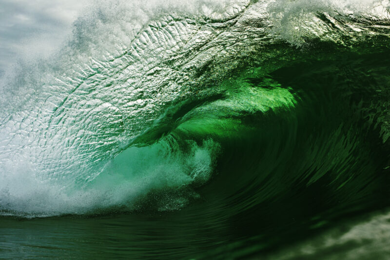 Emerald green wave breaking in the ocean
